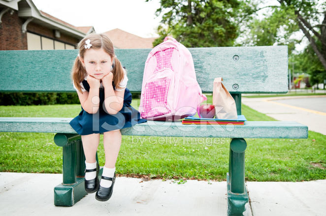 9979047-impatient-little-girl-student-waiting-on-bench-for-her-parents.jpg